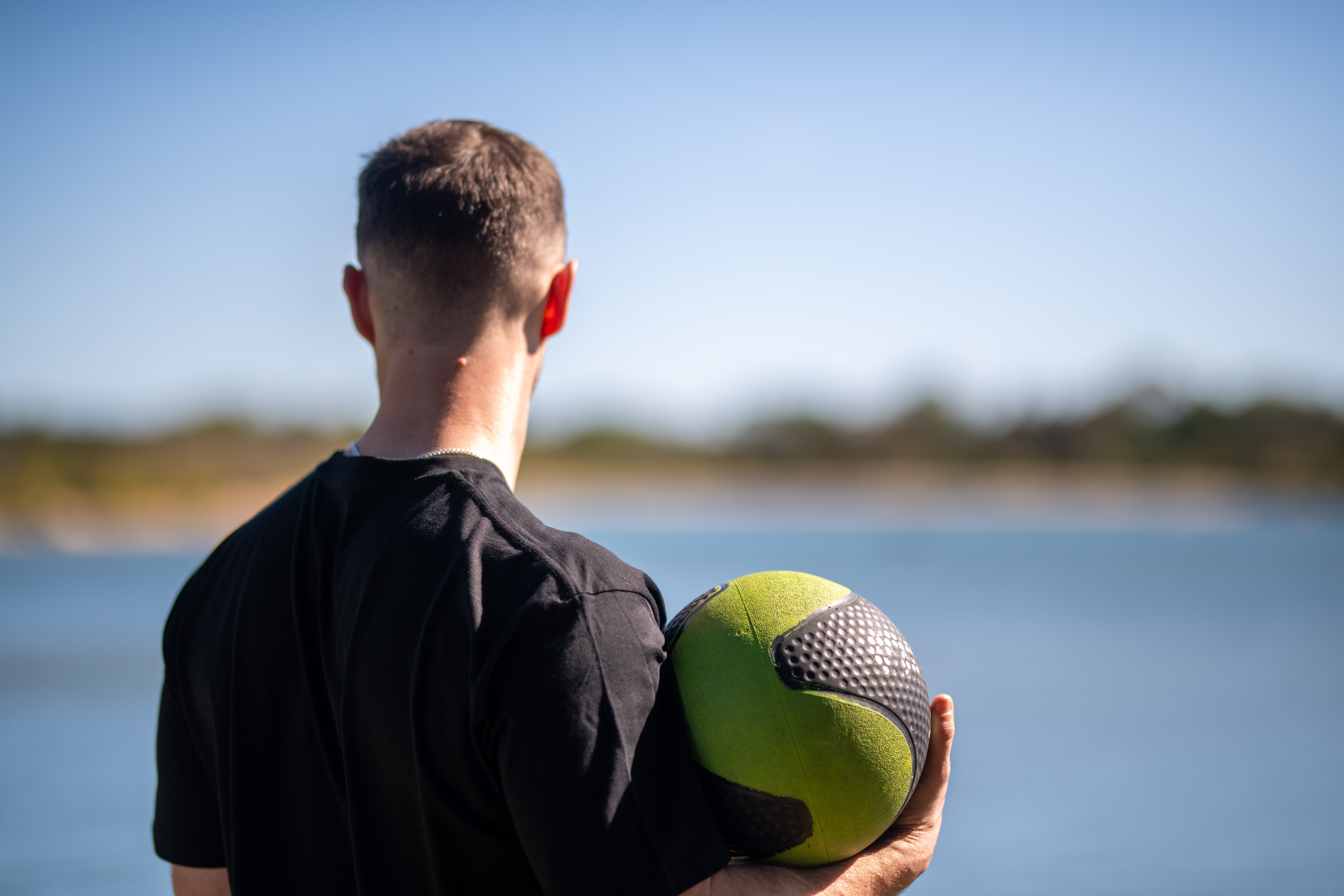 Isaac McCrimmon overlooking the Noosa river with exercise equipment, ready for an outdoor community session